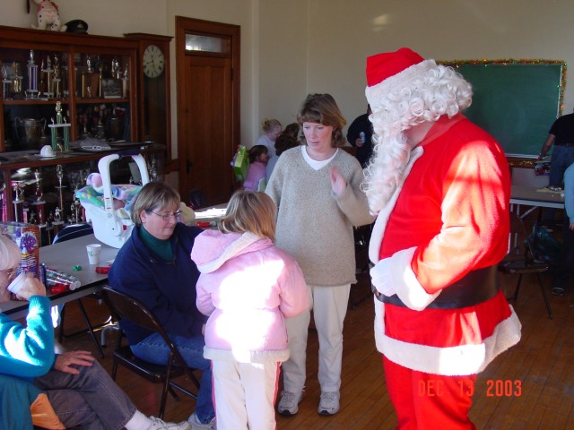 December 2003 - Santa making the rounds during the kid's Christmas party