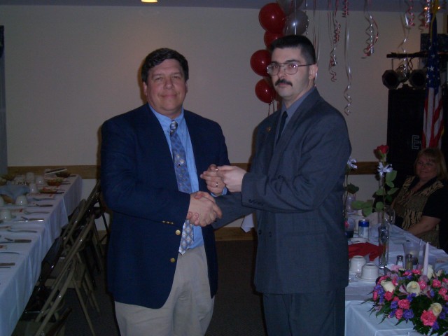 February 2004 - Assistant Chief Joe Goliber, on left, presented his service pin for 20 years by Chief Taylor