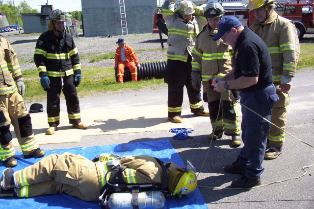 May 2005 - Firefighters receiving a demonstration from Deputy Chief &quot;Butch&quot;Cobb at the Mayday, Mayday- Firefighter Down training at the George E. Briggs Training Center In West Potsdam