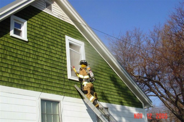 November 2005 - FF Conor Corbett vents a window at a house donated by CPH at 21 Grove Street