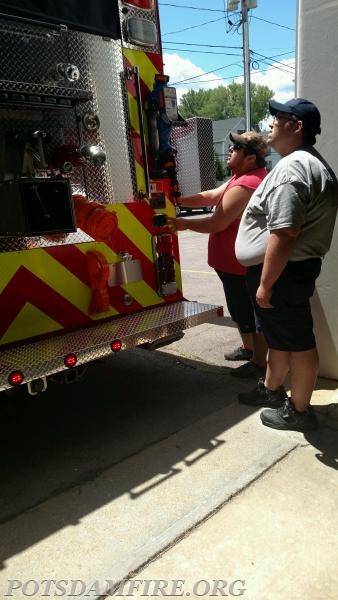 Justin McGregor getting a quick lesson from Fire Driver J. Robar on how to operate the mechanical arm that lowers the Port-a tank on the new E-80